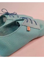 Soft leather slippers with lace-up closure for a perfect fit.