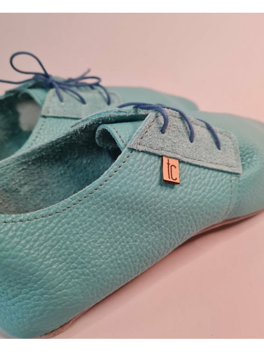 Soft leather slippers with lace-up closure for a perfect fit.