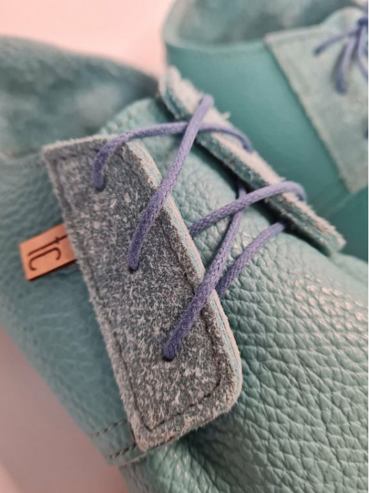 Soft leather slippers with lace-up closure for a perfect fit.